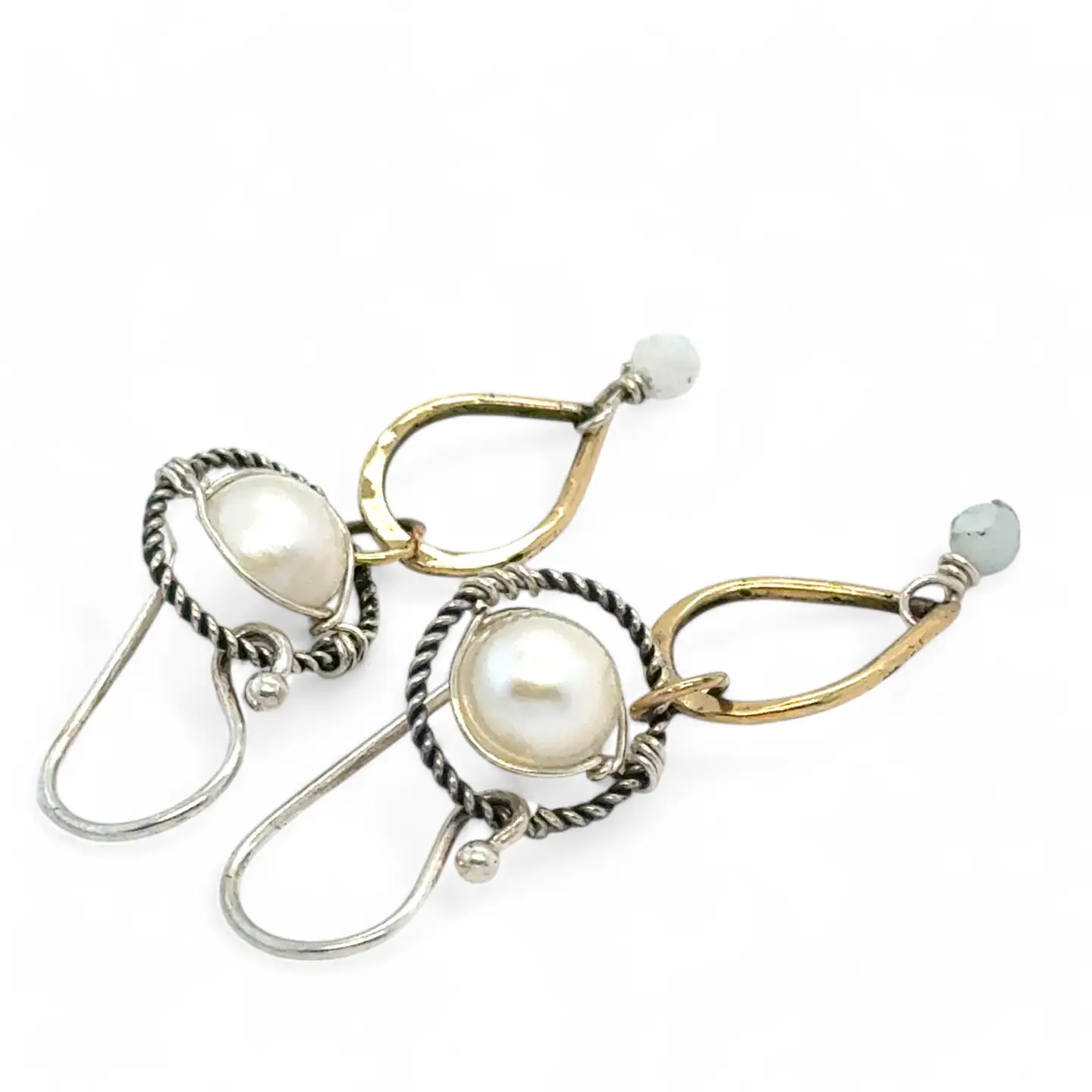 Brass hammered teardrops hanging from oxidized braided sterling rings holding a round fresh water pearl and faceted aquamarine earrings