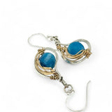 singular faceted apatite gemstone is held in layers of hammered gold filled wire on mini sterling silver paisley earrings