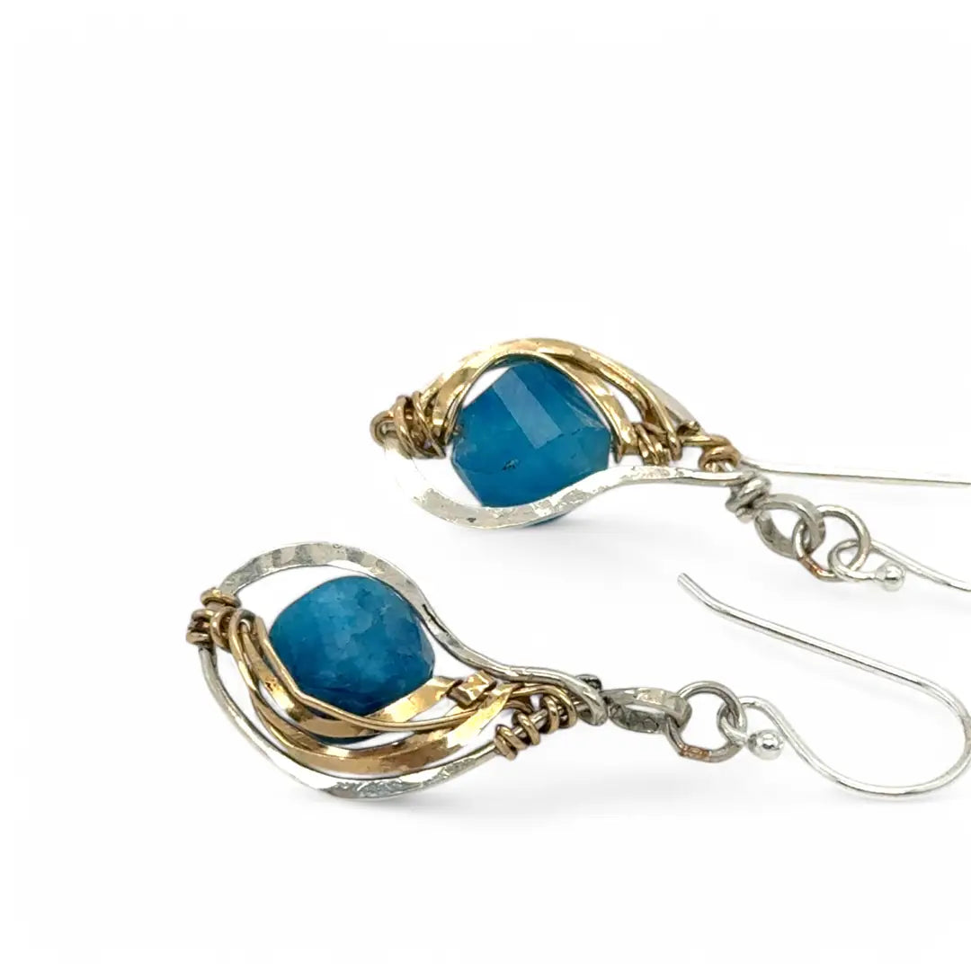 singular faceted apatite gemstone is held in layers of hammered gold filled wire on mini sterling silver paisley earrings
