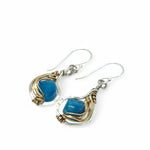 singular faceted apatite gemstone is held in layers of hammered gold filled wire on mini sterling silver paisley earrings