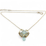 brass hammered mini pendant with aqua quartz tile lined in light blue cat's eye tiny gemstones with a faceted blue quartz drop at the bottom on gold filled chain necklace