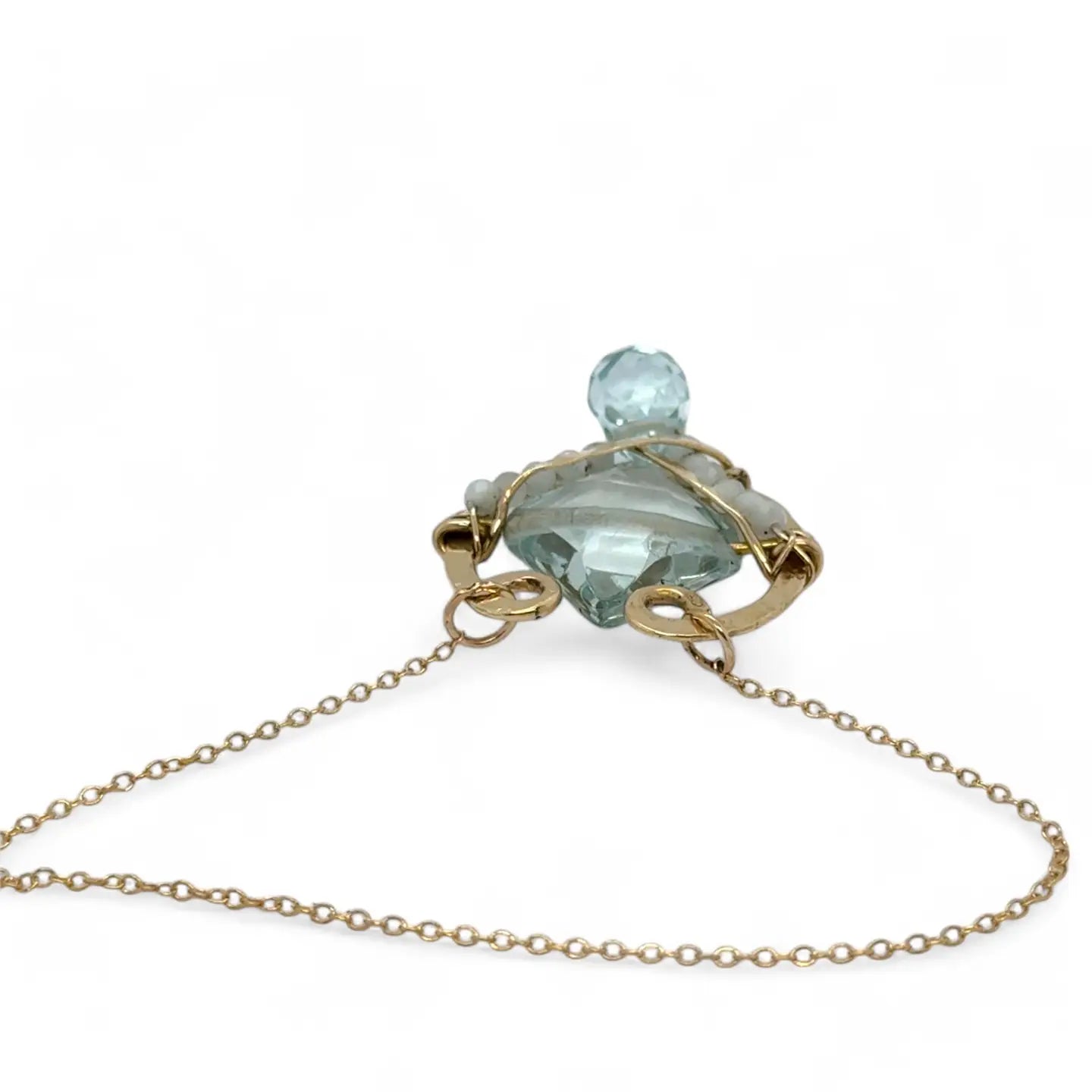 brass hammered mini pendant with aqua quartz tile lined in light blue cat's eye tiny gemstones with a faceted blue quartz drop at the bottom on gold filled chain necklace