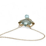 brass hammered mini pendant with aqua quartz tile lined in light blue cat's eye tiny gemstones with a faceted blue quartz drop at the bottom on gold filled chain necklace