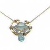 brass hammered mini pendant with aqua quartz tile lined in light blue cat's eye tiny gemstones with a faceted blue quartz drop at the bottom on gold filled chain necklace