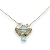 brass hammered mini pendant with aqua quartz tile lined in light blue cat's eye tiny gemstones with a faceted blue quartz drop at the bottom on gold filled chain necklace