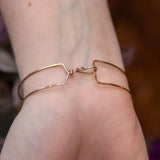 Chocolate pearl coin, striped brown agate, watermelon tourmaline, and cherry rutilated quartz gemstones held within our handmade bronze cuff on gold filled wire