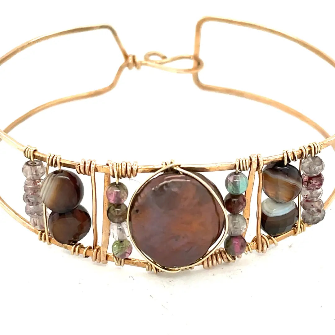 Chocolate pearl coin, striped brown agate, watermelon tourmaline, and cherry rutilated quartz gemstones held within our handmade bronze cuff on gold filled wire