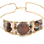 Chocolate pearl coin, striped brown agate, watermelon tourmaline, and cherry rutilated quartz gemstones held within our handmade bronze cuff on gold filled wire