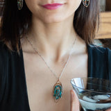 Bronze marquise pendant with a smooth chrysocolla drop nugget outlined in turquoise faceted gemstones on a sterling silver chain necklace