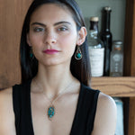 Bronze marquise pendant with a smooth chrysocolla drop nugget outlined in turquoise faceted gemstones on a sterling silver chain necklace