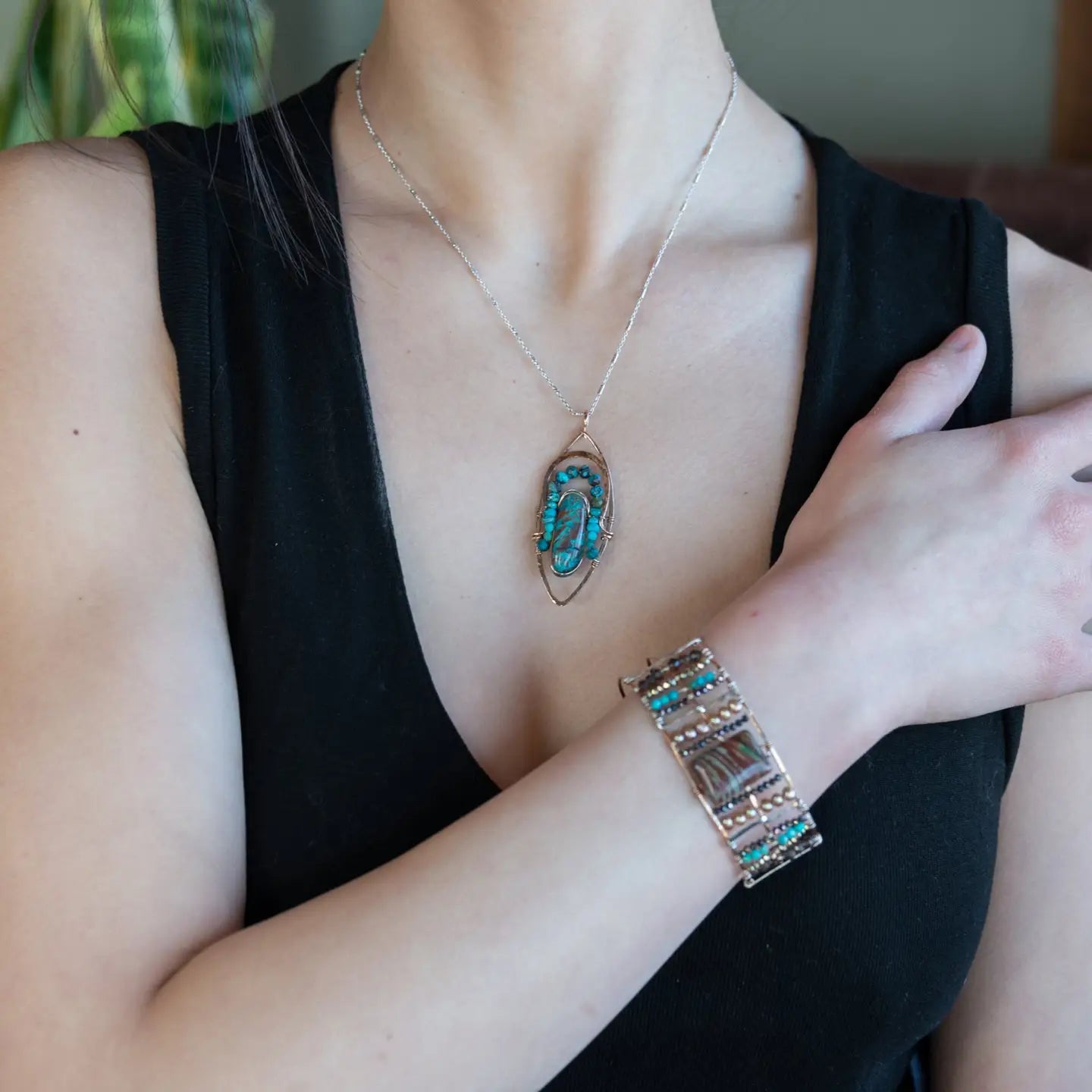 Bronze marquise pendant with a smooth chrysocolla drop nugget outlined in turquoise faceted gemstones on a sterling silver chain necklace