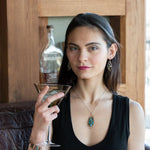 Bronze marquise pendant with a smooth chrysocolla drop nugget outlined in turquoise faceted gemstones on a sterling silver chain necklace