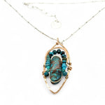 Bronze marquise pendant with a smooth chrysocolla drop nugget outlined in turquoise faceted gemstones on a sterling silver chain necklace