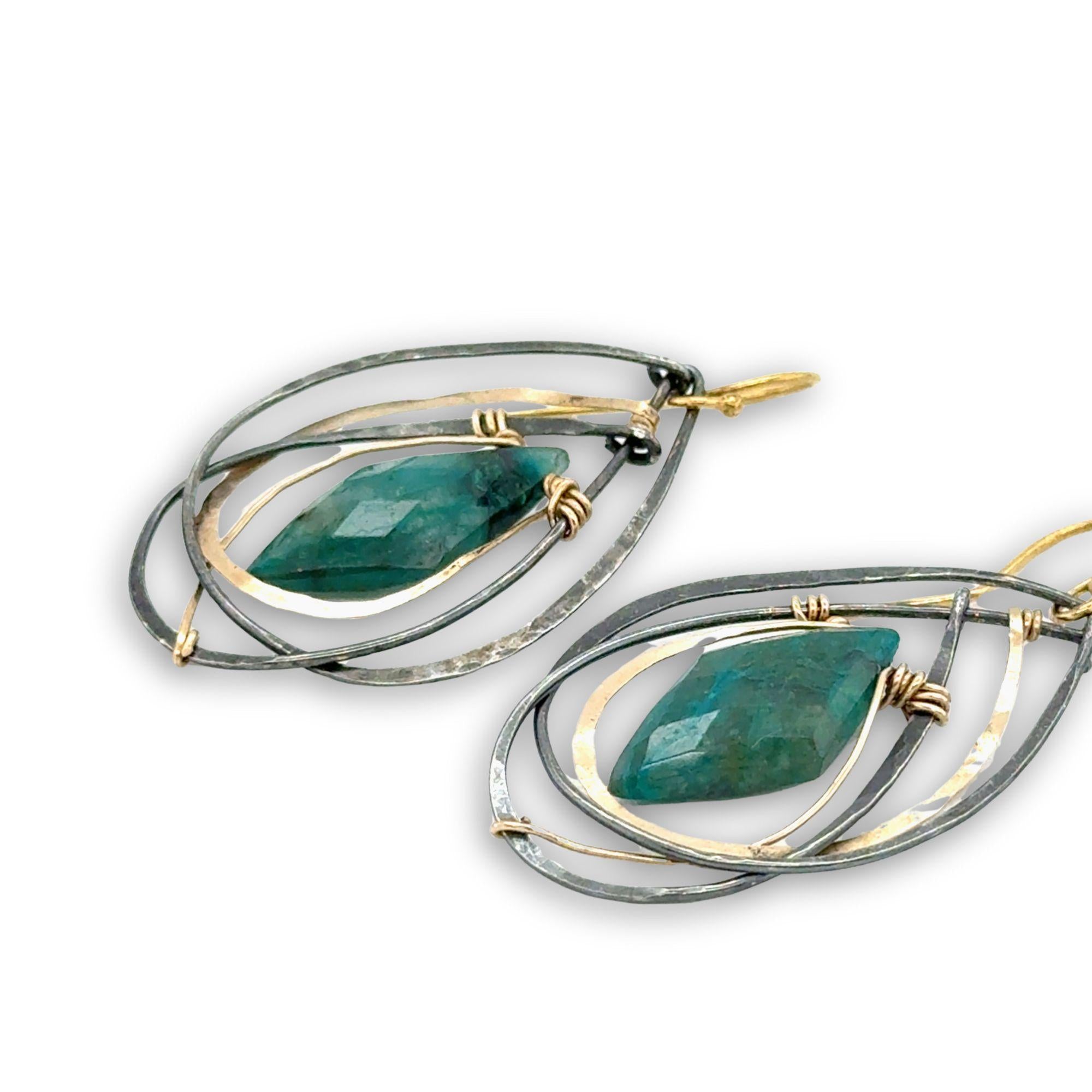 Double pointed chrysocolla gemstones are held in layers of gold filled and oxidized sterling silver earrings