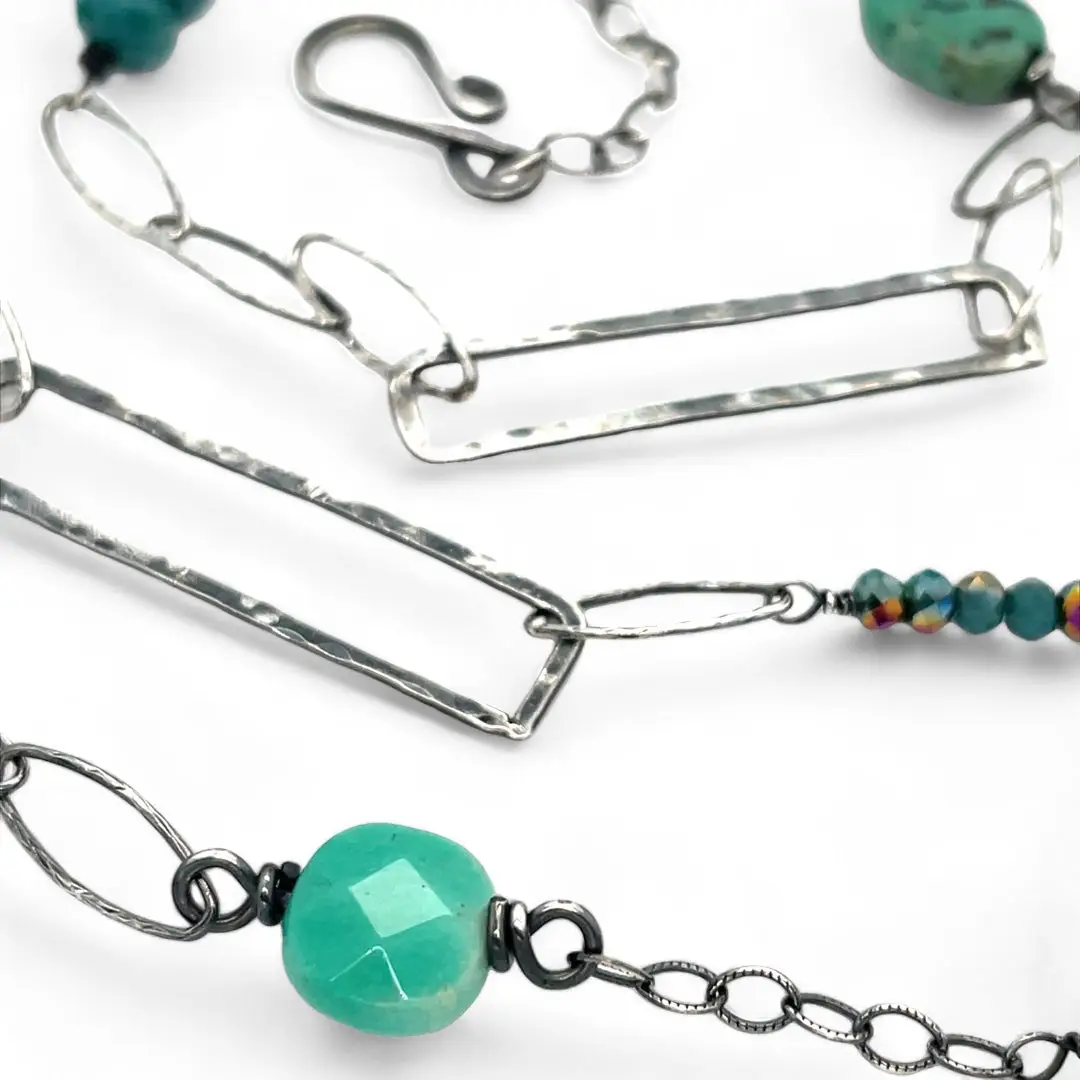 Handmade darkened sterling silver rectangle and diamond links interspersed with sparkly diamond cut links, teal crystal, and chrysoprase gemstones to form this long necklace that can be worn at any length