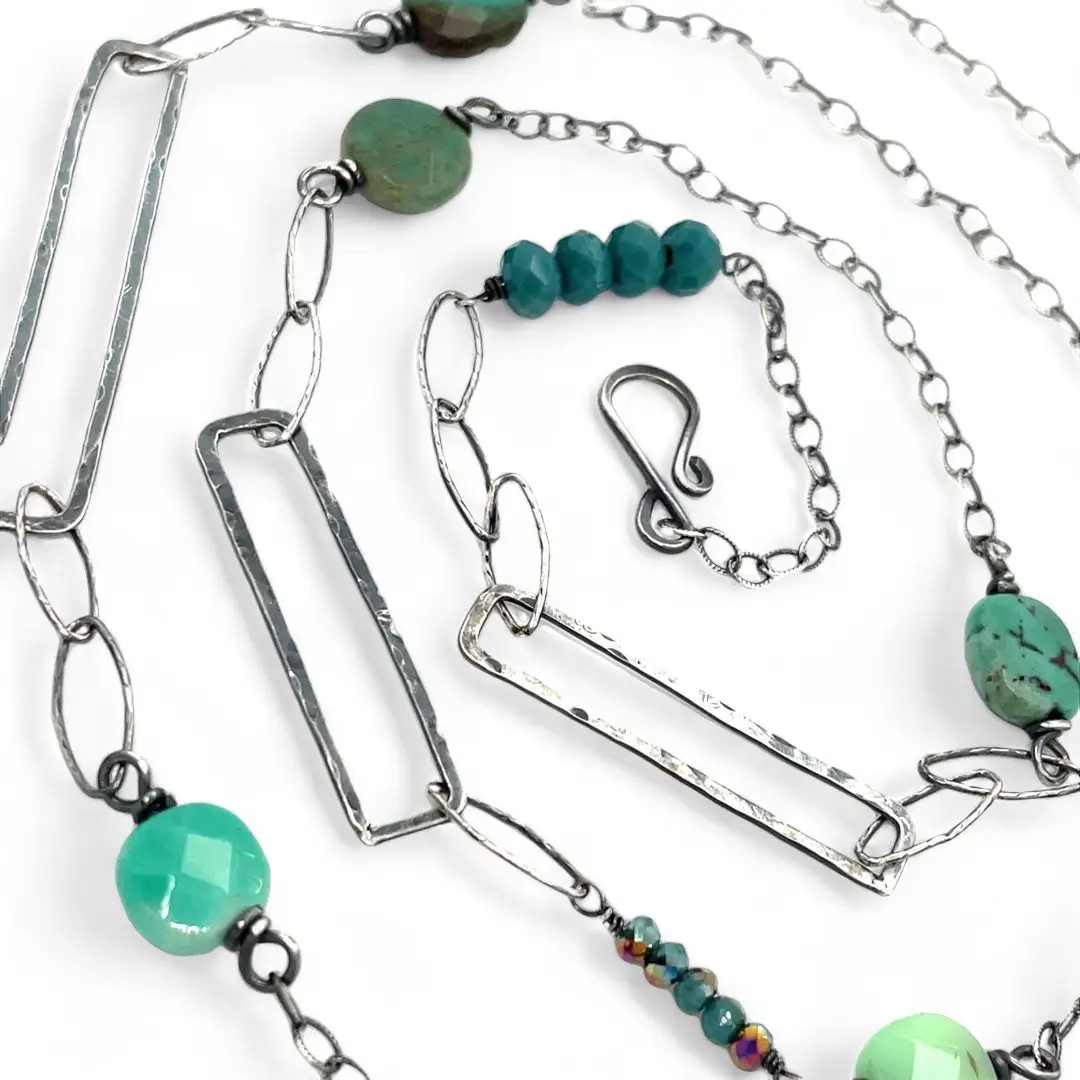 Handmade darkened sterling silver rectangle and diamond links interspersed with sparkly diamond cut links, teal crystal, and chrysoprase gemstones to form this long necklace that can be worn at any length