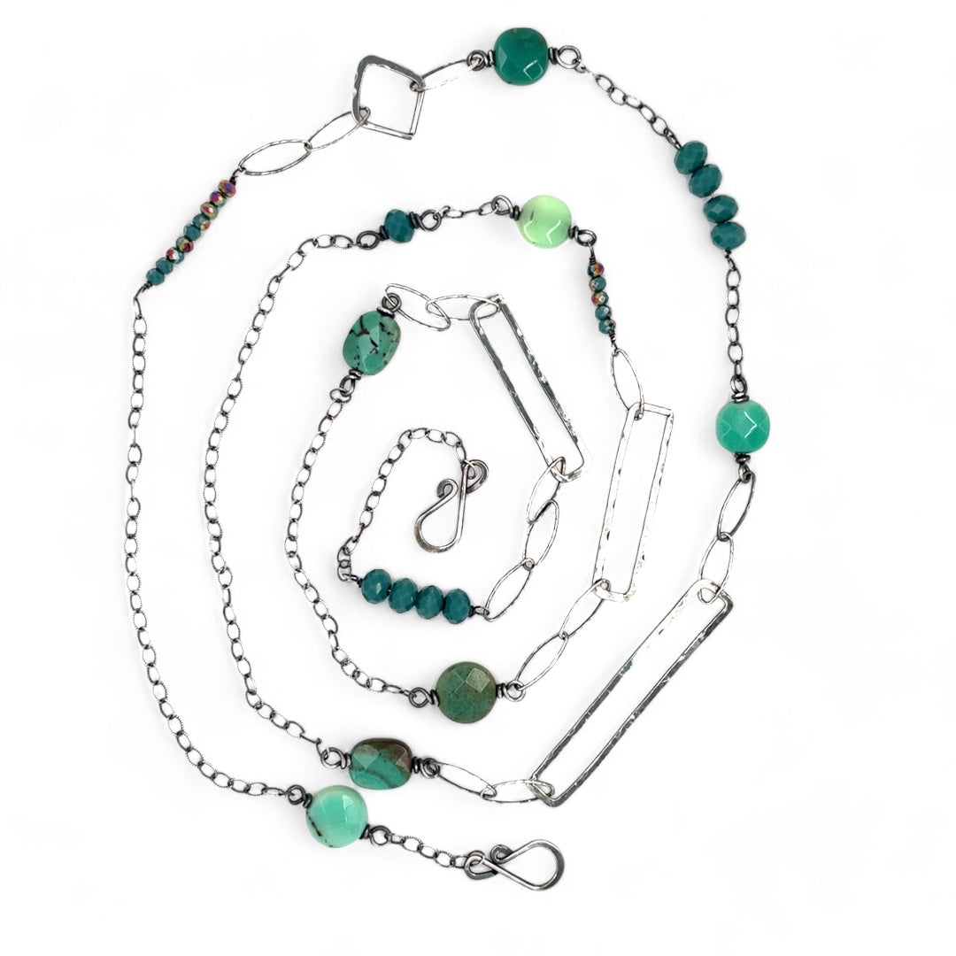 Handmade darkened sterling silver rectangle and diamond links interspersed with sparkly diamond cut links, teal crystal, and chrysoprase gemstones to form this long necklace that can be worn at any length