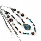 double strand darkened sterling silver necklace with chrysocolla, chocolate fresh water pearl, striped brown agate, and a chrysocolla faceted gemstone drop
