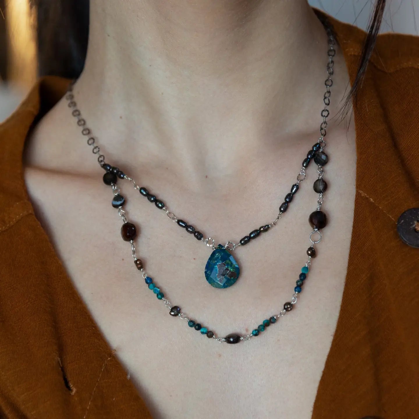 double strand darkened sterling silver necklace with chrysocolla, chocolate fresh water pearl, striped brown agate, and a chrysocolla faceted gemstone drop