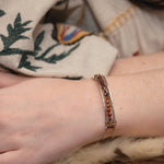 Sterling silver skinny bracelet with hessonite garnet coins and pyrite gemstones, lined with oxidized sterling silver twist wires