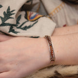 Sterling silver skinny bracelet with hessonite garnet coins and pyrite gemstones, lined with oxidized sterling silver twist wires