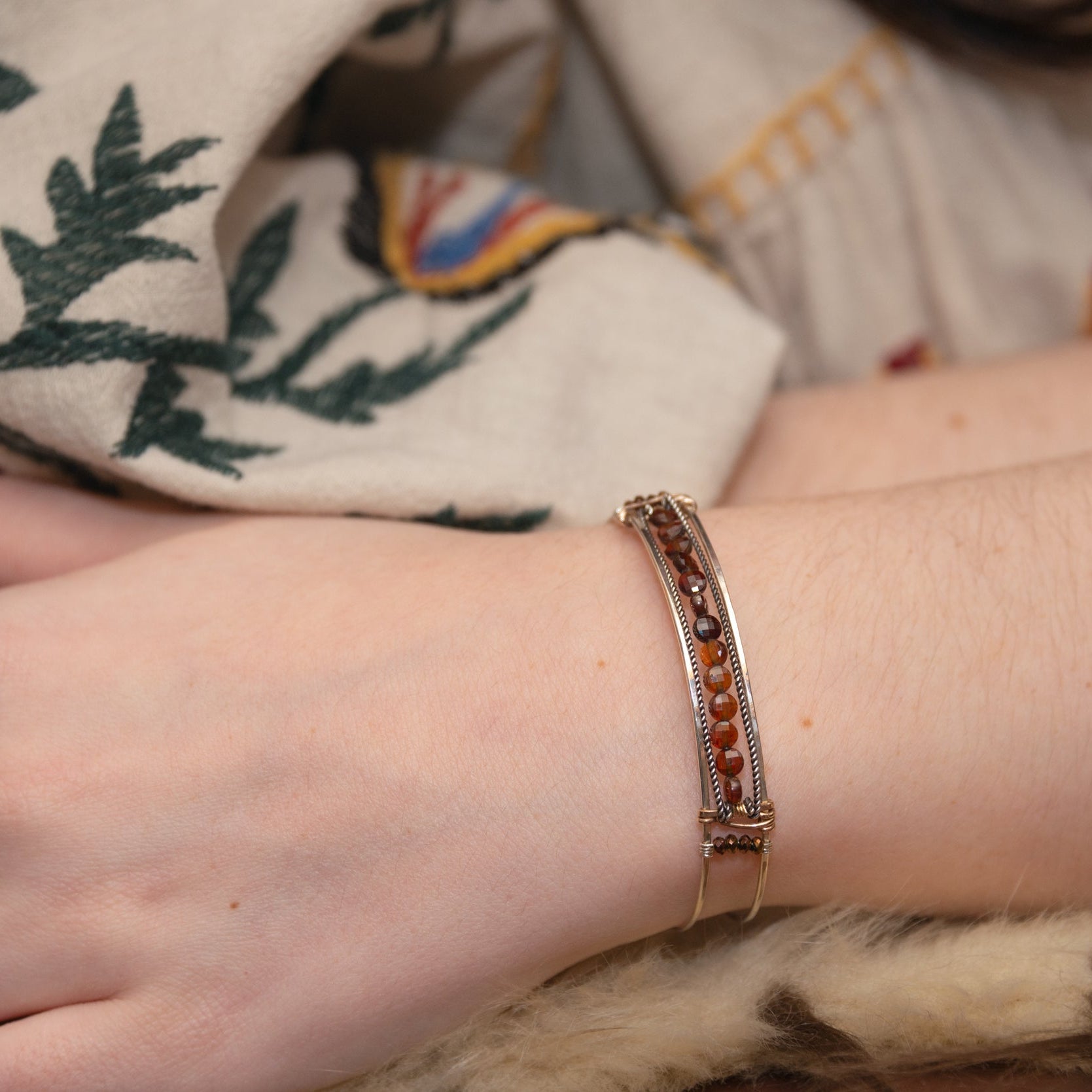 Sterling silver skinny bracelet with hessonite garnet coins and pyrite gemstones, lined with oxidized sterling silver twist wires