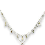 a double layered necklace, the first layer with a Bronze marquise pendant embellished with a faceted citrine coin, prehnite, and turquoise gemstones on sterling silver wire, and the second layer with delicate gemstone charms