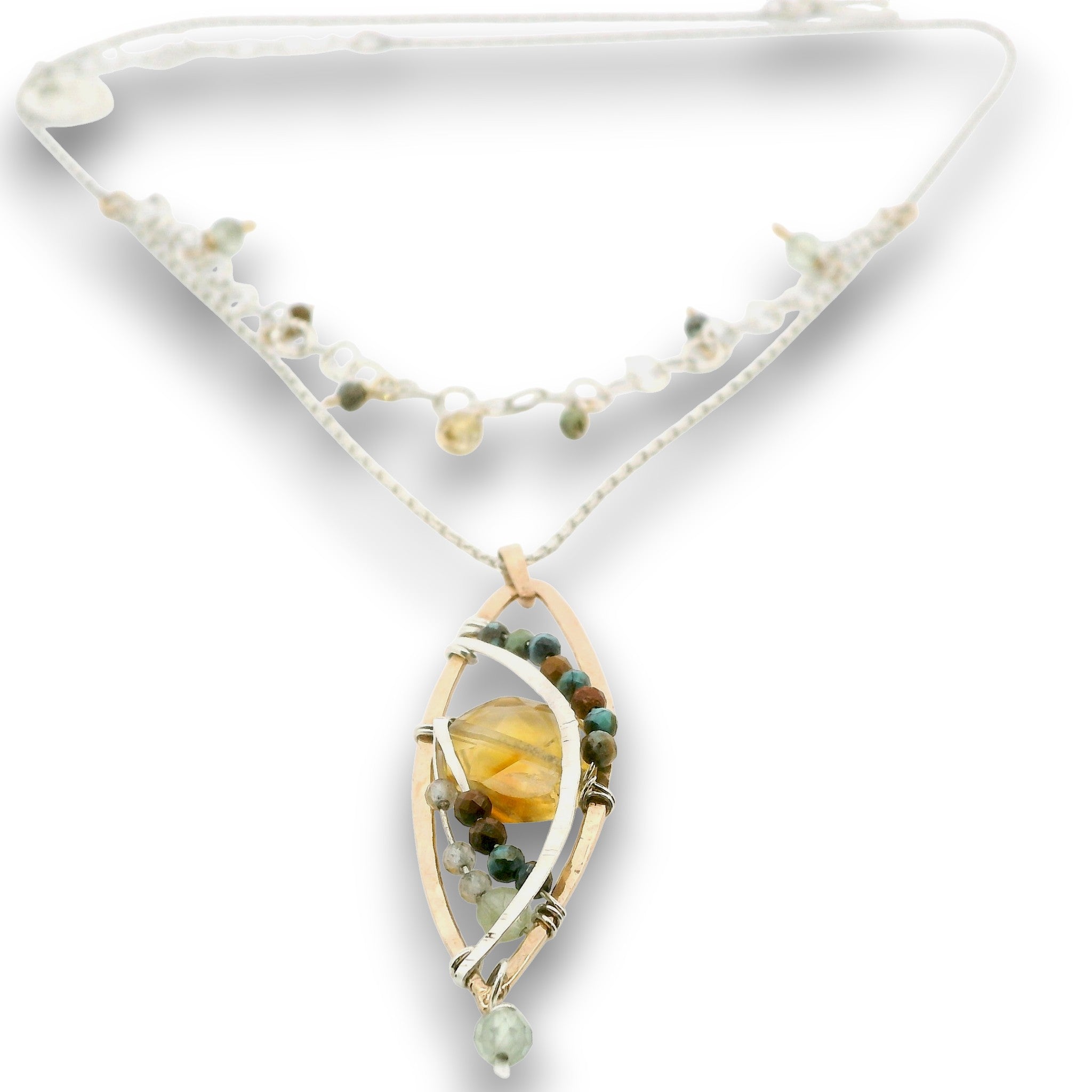 a double layered necklace, the first layer with a Bronze marquise pendant embellished with a faceted citrine coin, prehnite, and turquoise gemstones on sterling silver wire, and the second layer with delicate gemstone charms