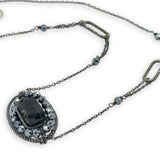 raw black tourmaline within pyrite gemstones inside a sterling silver darkened twist wire oval pendant on a darkened chain with sparkly links necklace
