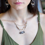 Brown oval jasper held in sterling silver is layered with fresh water pearl, gold filled chain, and pyrite gemstones to form an already layered necklace