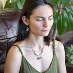 Brown oval jasper held in sterling silver is layered with fresh water pearl, gold filled chain, and pyrite gemstones to form an already layered necklace