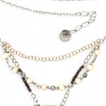Brown oval jasper held in sterling silver is layered with fresh water pearl, gold filled chain, and pyrite gemstones to form an already layered necklace