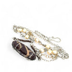 Brown oval jasper held in sterling silver is layered with fresh water pearl, gold filled chain, and pyrite gemstones to form an already layered necklace