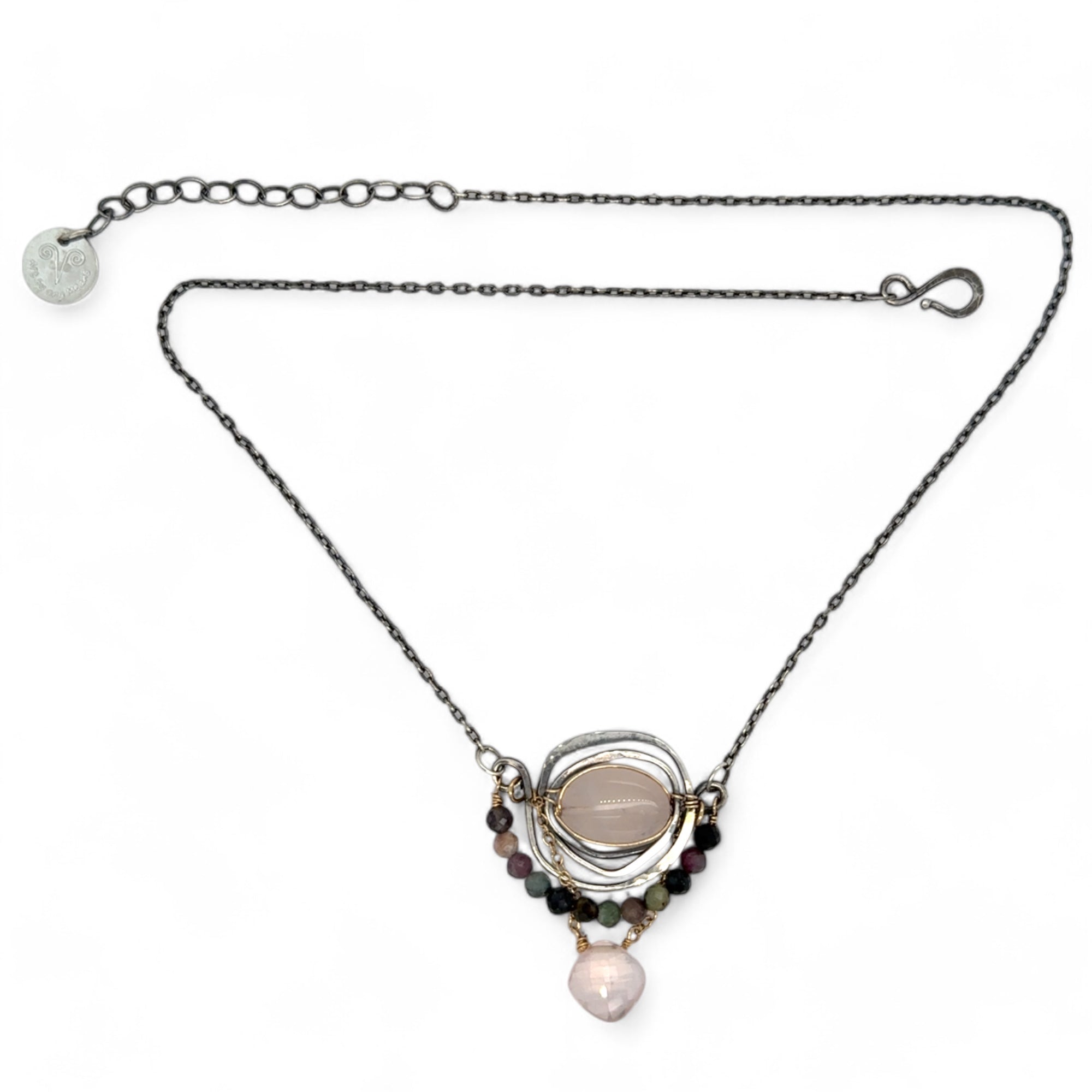 a smooth rose quartz oval is held in an oxidized sterling silver spiral pendant accompanied by tourmaline gemstones with a faceted rose quartz gemstone drop with gold filled delicate chain accent necklace
