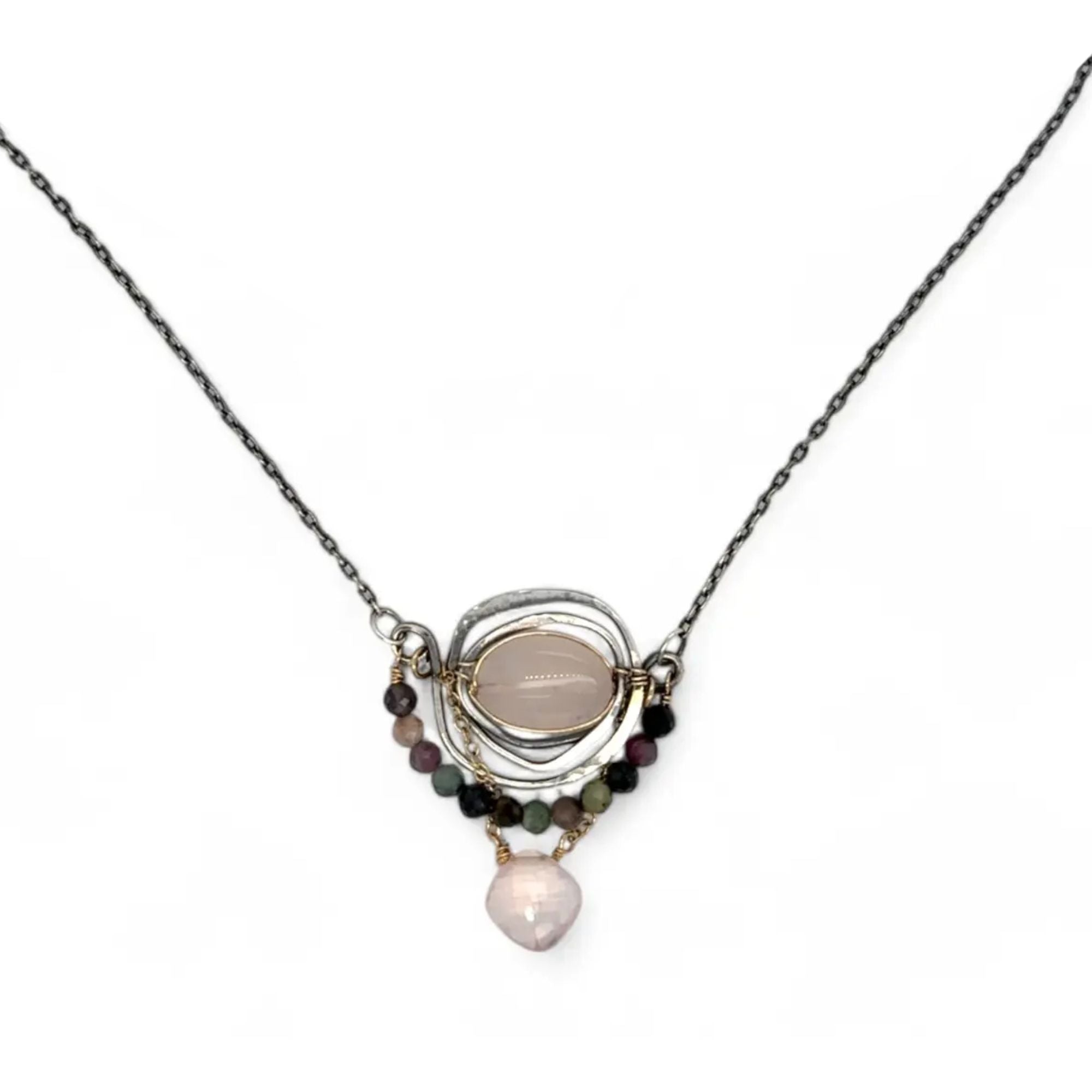 a smooth rose quartz oval is held in an oxidized sterling silver spiral pendant accompanied by tourmaline gemstones with a faceted rose quartz gemstone drop with gold filled delicate chain accent necklace