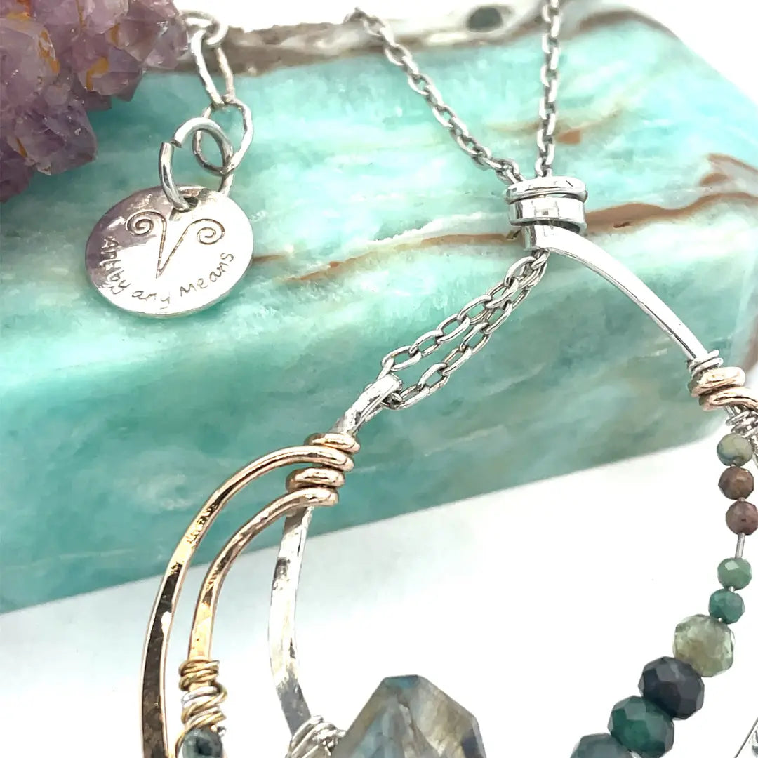 A hand formed bronze and sterling silver pendant necklace with a slide  sterling silver chain, featuring faceted natural tourmaline, green amethyst and flashy labradorite gemstones