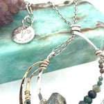A hand formed bronze and sterling silver pendant necklace with a slide  sterling silver chain, featuring faceted natural tourmaline, green amethyst and flashy labradorite gemstones