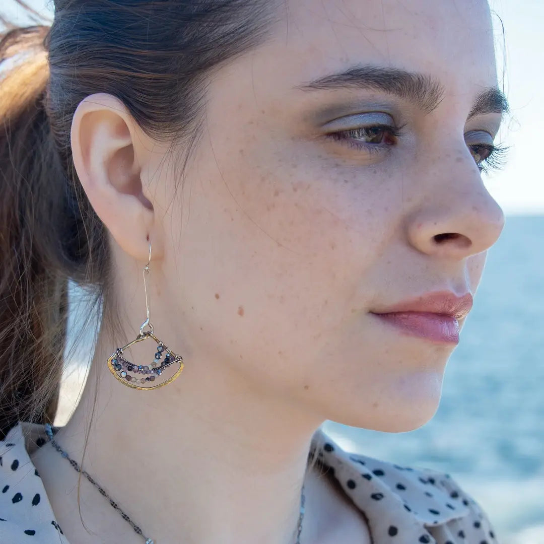 Brass fans suspended by a floral stamped sterling silver paddle with oxidized sterling twist wire, mixed color gemstone, cubic zirconia, and pyrite faceted gemstones