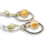 darkened sterling silver twist rings with citrine orbs hanging in them, swinging from sterling silver hammered polygons with prehnite and green cubic zirconia gemstone earrings