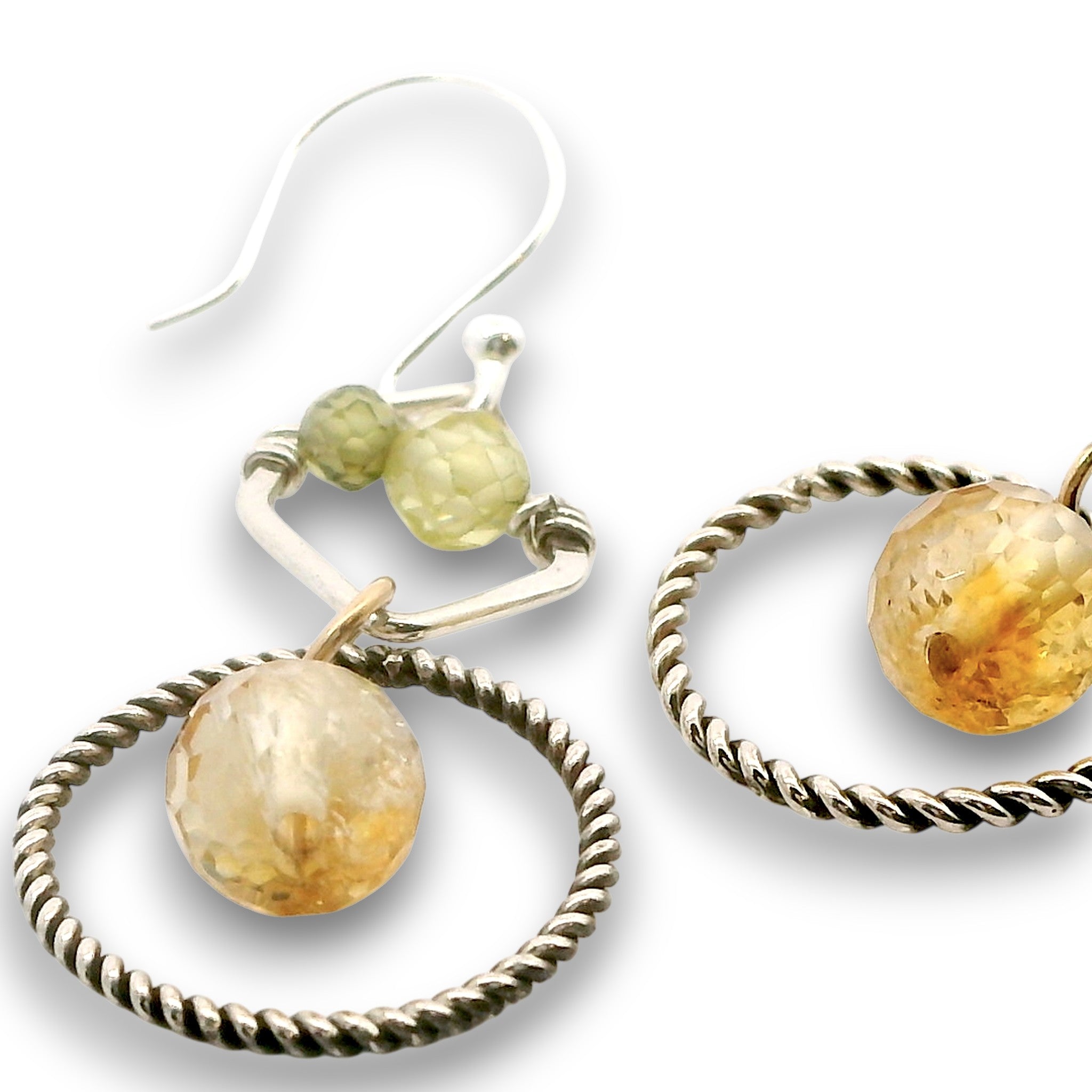 darkened sterling silver twist rings with citrine orbs hanging in them, swinging from sterling silver hammered polygons with prehnite and green cubic zirconia gemstone earrings
