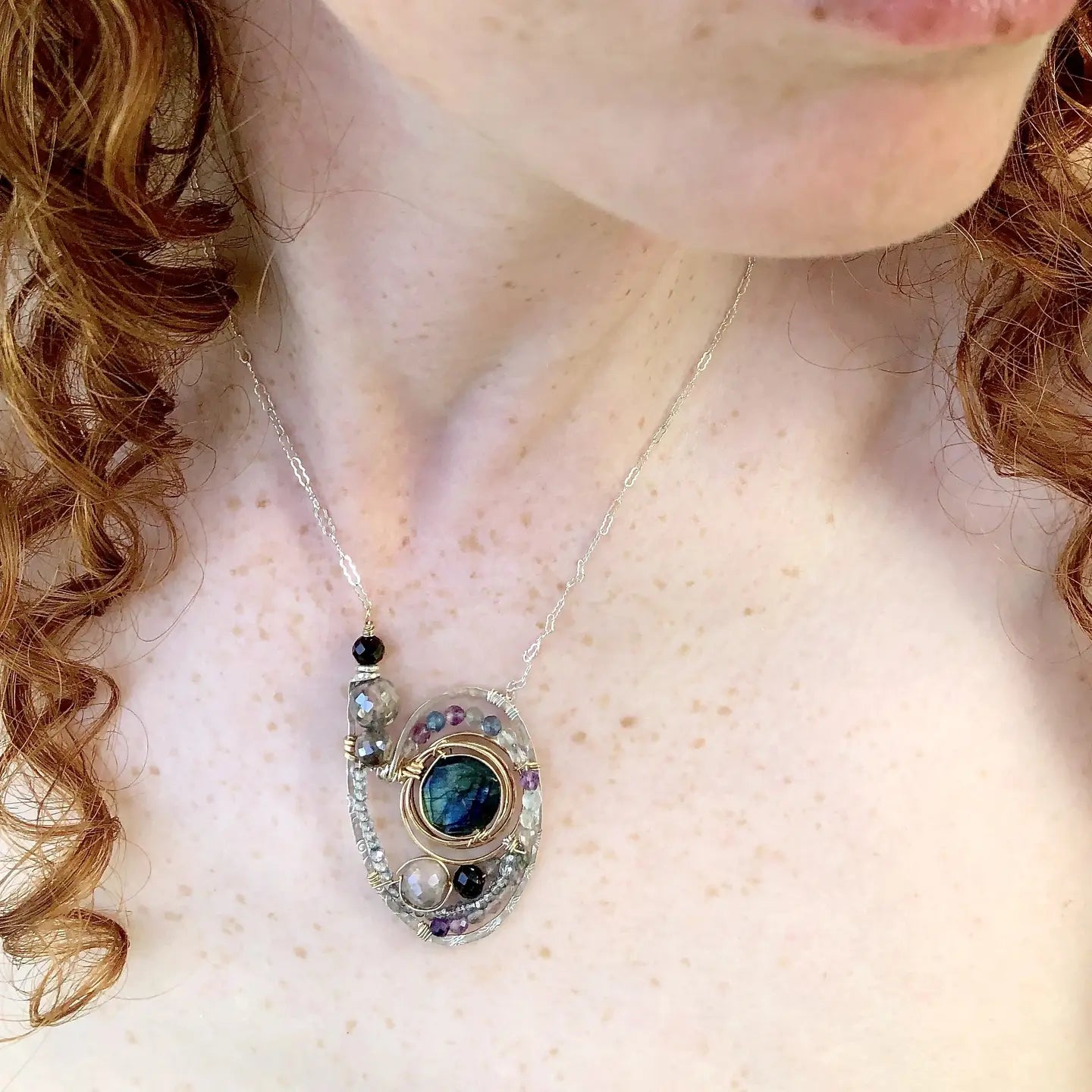 Stamped sterling silver and bronze knot milkyway necklace a flashy labradorite coin, mauve moonstone spheres, garnet sphere, mixed fluorite gemstones, and apatite mini gemstones on gold filled wire