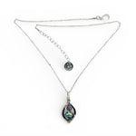 A mini sterling silver marquise pendant with abalone shell tile, purple crystal, and cubic zirconia on a sterling silver sparkle chain necklace