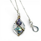 A mini sterling silver marquise pendant with abalone shell tile, purple crystal, and cubic zirconia on a sterling silver sparkle chain necklace