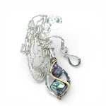 A mini sterling silver marquise pendant with abalone shell tile, purple crystal, and cubic zirconia on a sterling silver sparkle chain necklace