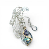 A mini sterling silver marquise pendant with abalone shell tile, purple crystal, and cubic zirconia on a sterling silver sparkle chain necklace