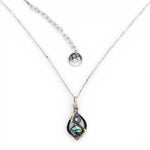 A mini sterling silver marquise pendant with abalone shell tile, purple crystal, and cubic zirconia on a sterling silver sparkle chain necklace