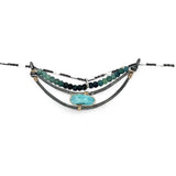 A darkened sterling silver crescent necklace  featuring a bright blue druzy quartz slab and ombre blue tourmaline gemstones on gold filled wire