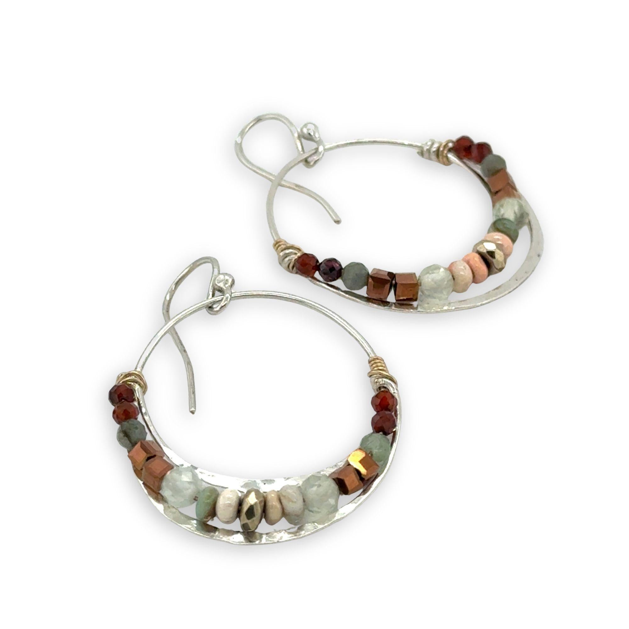 Sterling silver channel hoop earrings with a line of opal, pyrite, green amethyst, and hessonite garnet gemstones on gold filled wire