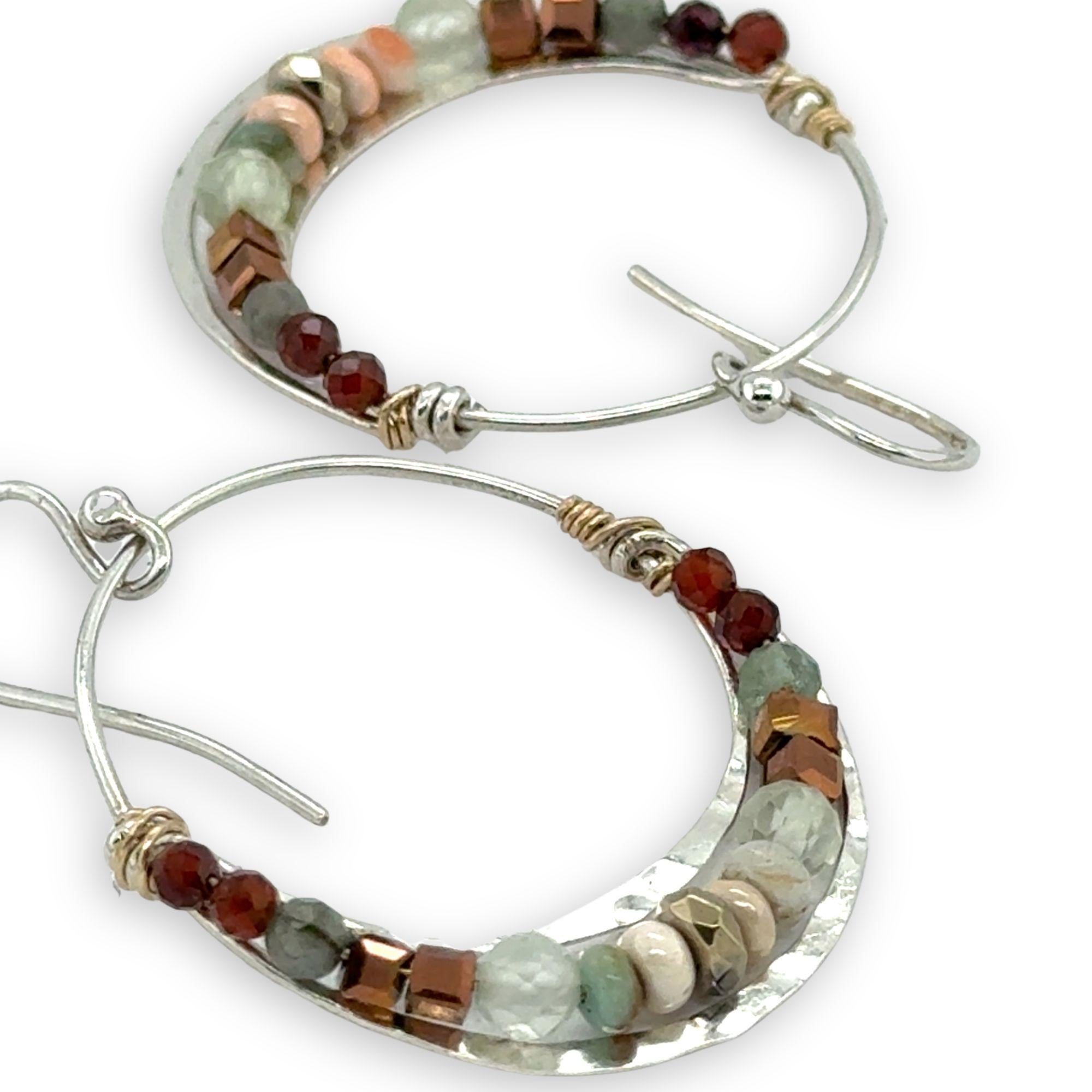 Sterling silver channel hoop earrings with a line of opal, pyrite, green amethyst, and hessonite garnet gemstones on gold filled wire