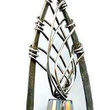 blue green crystal cone inside a brass chapel shaped earring woven with sterling silver fine wire